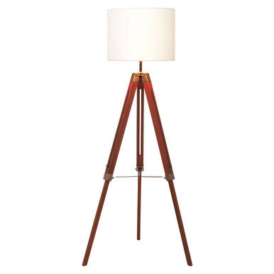 Malvern Brown Wood Tripod Floor Lamp with white linen shade and natural brown pine wood tripod legs in a warm living room setup