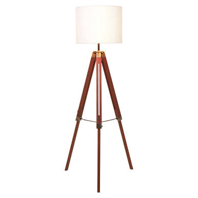 Malvern Brown Wood Tripod Floor Lamp with white linen shade and natural brown pine wood tripod legs in a warm living room setup