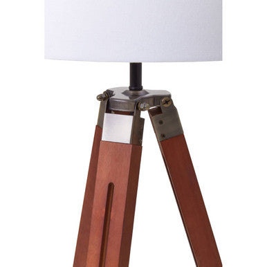 Malvern Brown Wood Tripod Floor Lamp with white linen shade and natural brown pine wood tripod legs in a warm living room setup