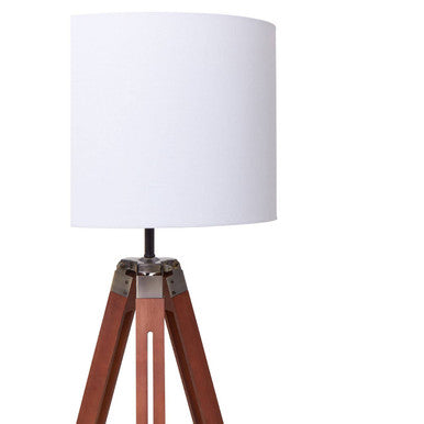 Malvern Brown Wood Tripod Floor Lamp with white linen shade and natural brown pine wood tripod legs in a warm living room setup