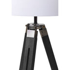Malvern Black Wood Tripod Floor Lamp with white linen shade and black pine wood tripod legs in a modern living room