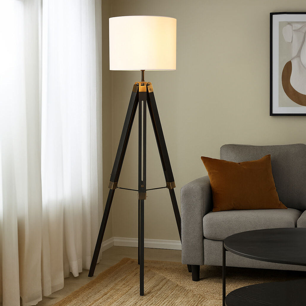 Malvern Black Wood Tripod Floor Lamp with white linen shade and black pine wood tripod legs in a modern living room