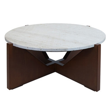 Winton Coffee Table with a round cream travertine stone top resting on an angular brown acacia wood geometric base in a modern living room