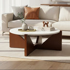 Winton Coffee Table with a round cream travertine stone top resting on an angular brown acacia wood geometric base in a modern living room