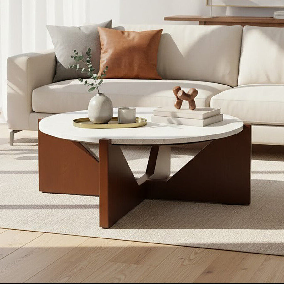 Winton Coffee Table with a round cream travertine stone top resting on an angular brown acacia wood geometric base in a modern living room
