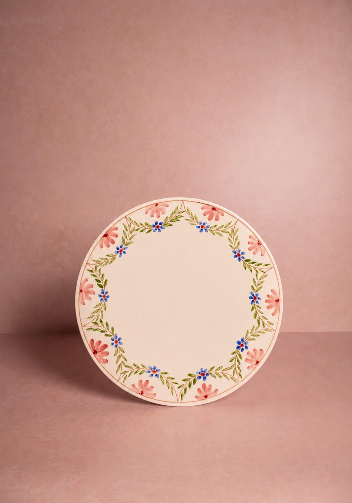 Decorative plate with floral design on a pink background