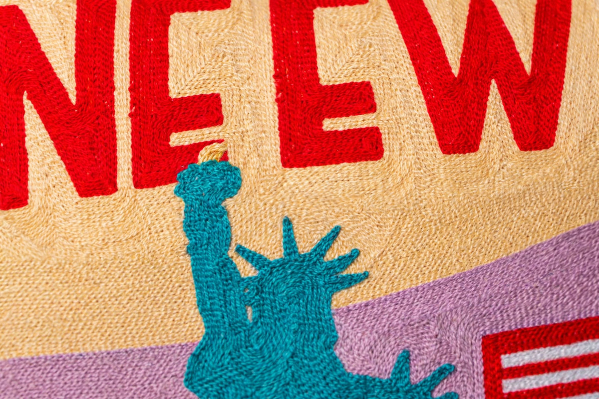 New York City hand-stitched needlepoint throw pillow featuring a colorful geometric NYC skyline design with a soft reversible velvet backing