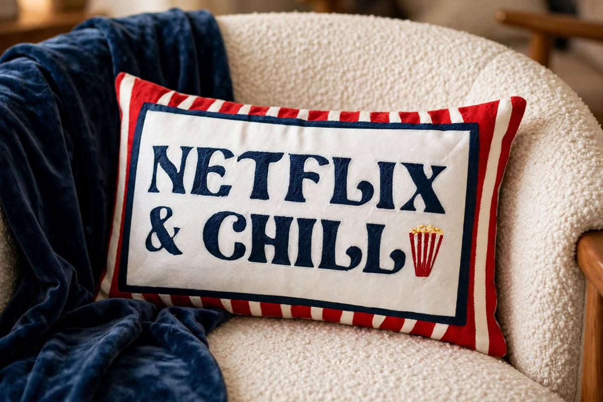 Netflix & Chill hand-stitched needlepoint throw pillow featuring red stripes and popcorn details with a soft reversible velvet backing