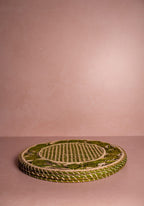 Woven green mat on a pink background
