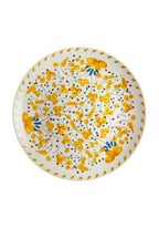 Decorative plate with yellow floral pattern on a white background